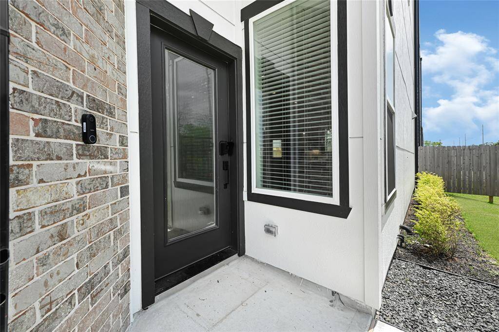 Charming covered entry with modern curb appeal—welcome guests in style with a clean, inviting entryway and contemporary exterior design.