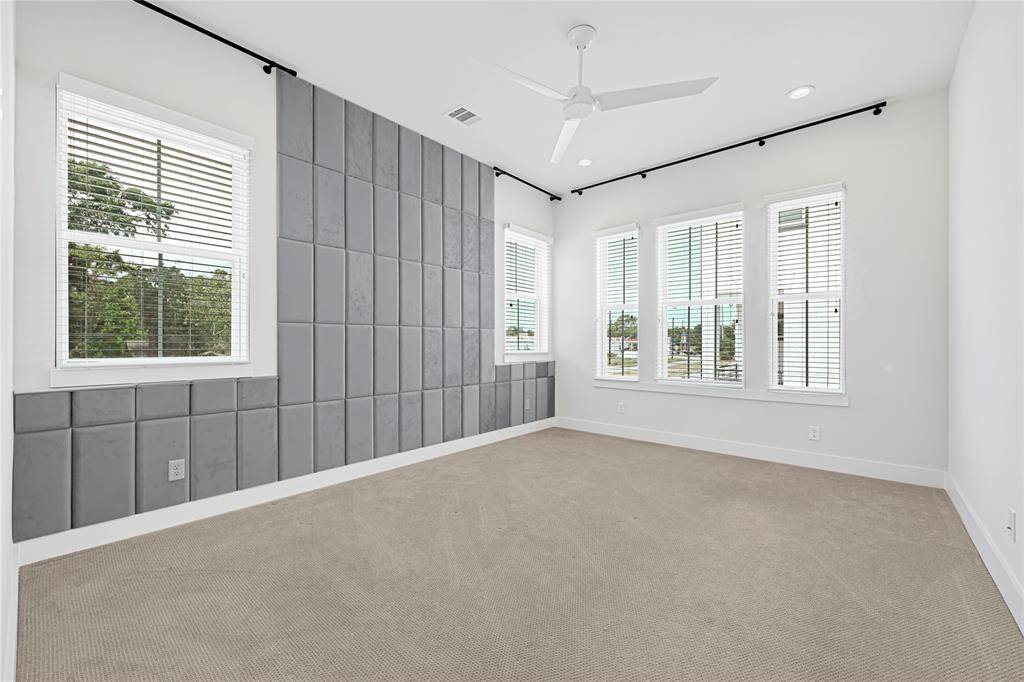Spacious primary suite with two closets and serene natural lighting.