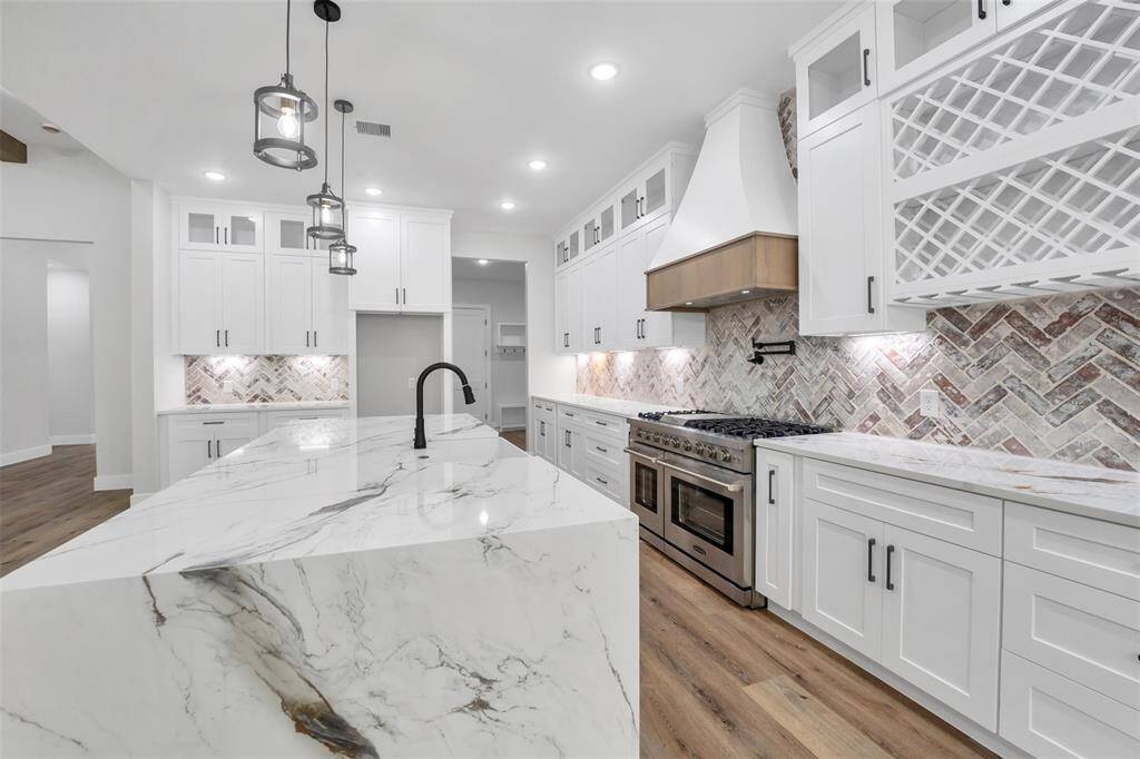 The island serves as both a practical workspace and a stylish centerpiece, providing ample room for meal preparation, casual dining, and entertaining guests