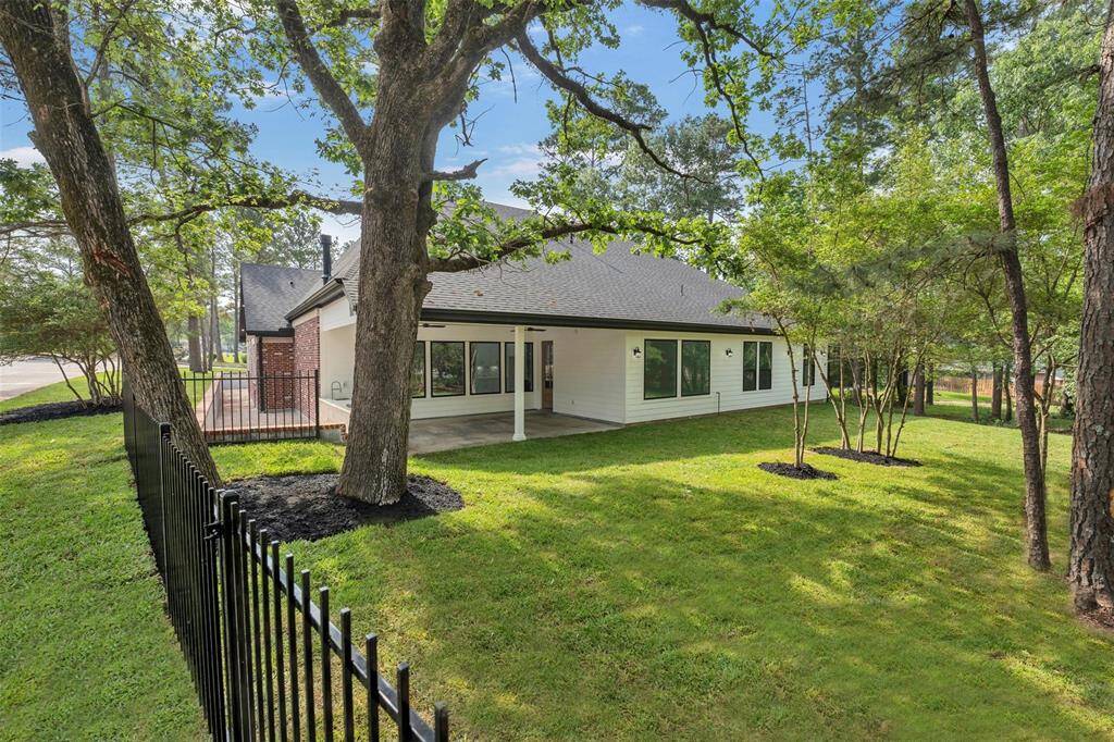 Step outside to the tranquil wooded backyard, where you can relax and unwind on the wide porch. The fully equipped summer kitchen is ideal for outdoor entertaining, allowing you to host memorable gatherings with family and friends in a picturesque setting