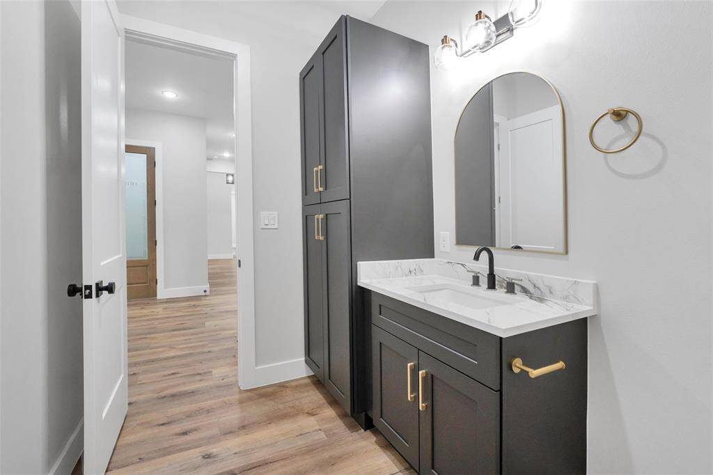 The exceptionally spacious laundry room is a standout feature, with direct access to one of the primary bedrooms, making daily chores more manageable and efficient.