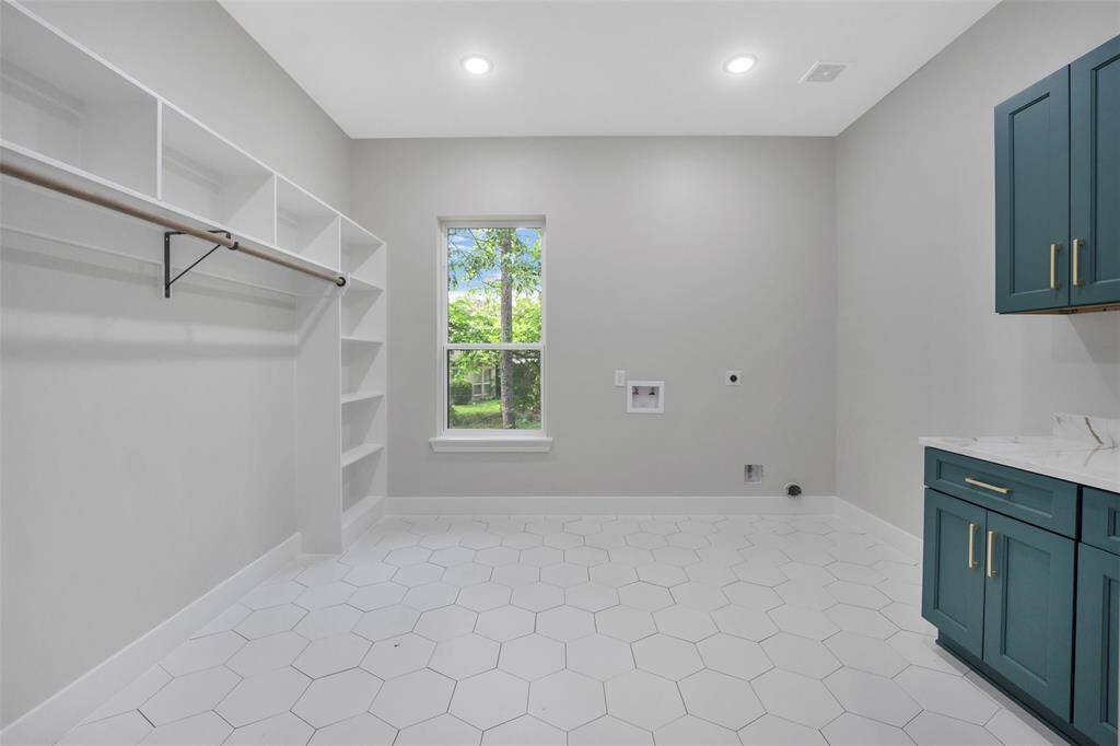 The standout feature of this particular laundry room is its exceptional spaciousness