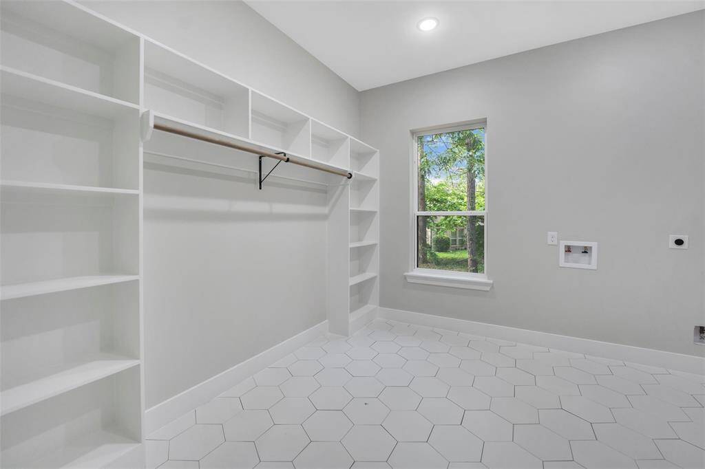 Adjoining the primary bedroom is a lavish bathroom designed for relaxation and rejuvenation