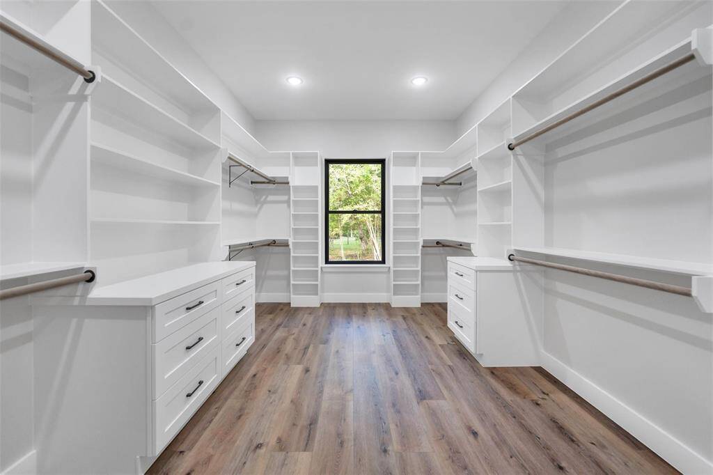 The primary bedroom is spacious, boasting high ceilings, natural light, making it a perfect retreat