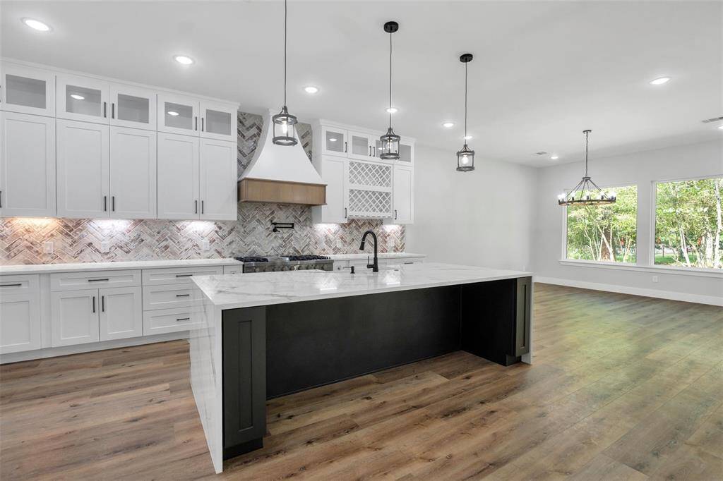 Featuring a stunning waterfall island, this kitchen blends functionality with aesthetic appeal