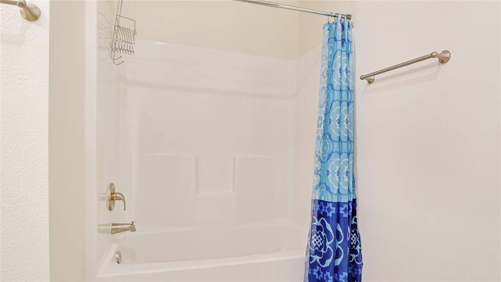 The secondary bathroom is large and open and consists of a shower/tub combintation.