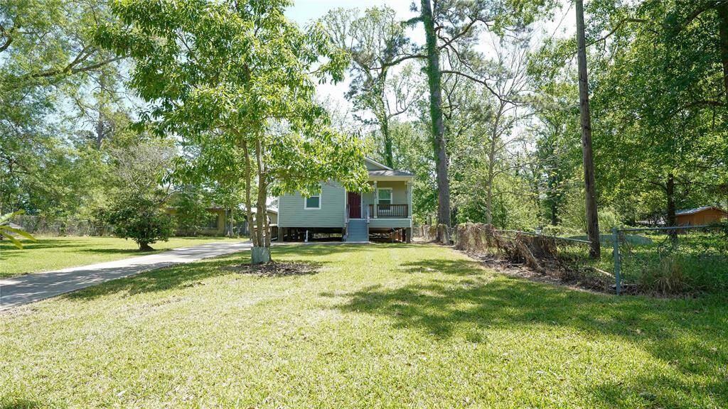 From the end of the driveway, you’ll catch the full view of this charming country styled home—nestled among mature trees, with a wide front porch that invites you in. The long drive highlights the spacious front yard, offering a peaceful, private setting just minutes from town.