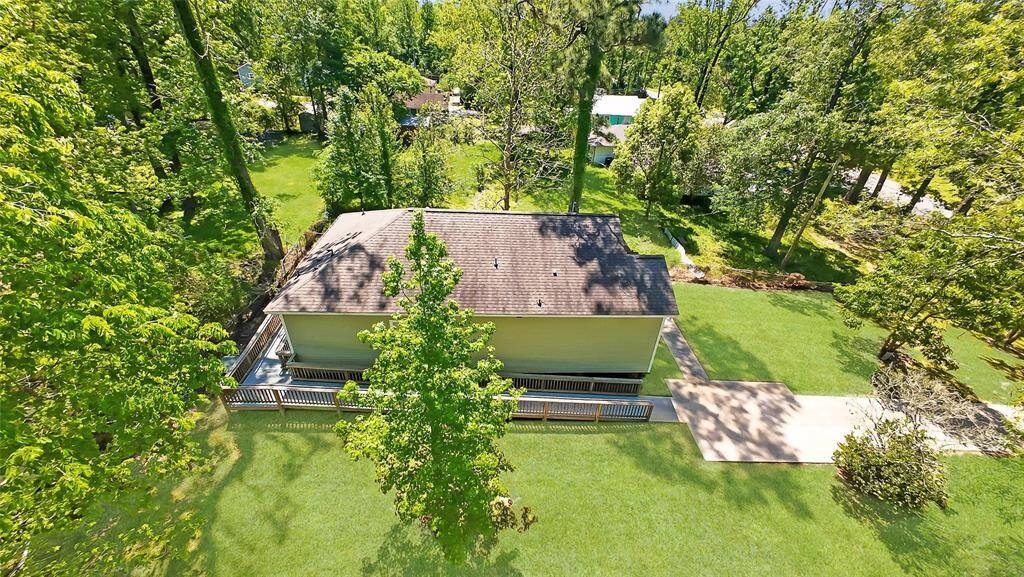 This aerial view showcases peaceful country living—spacious front yard, mature trees, and endless potential for outdoor living or expansion. A true private retreat with wide-open skies.