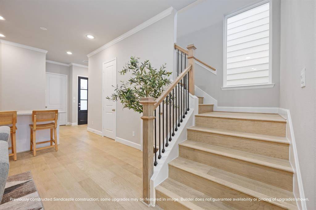Warm wood tones and iron balusters elevate the staircase, setting the scene as you head upstairs to unwind.