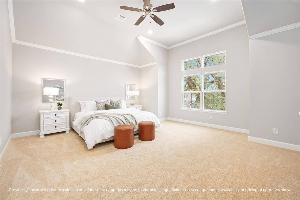 The primary bedroom is a serene retreat with tall ceilings, soft carpet, and space to breathe—perfect for lazy mornings and restful nights.