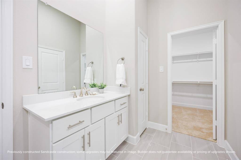 Dual vanities and ample storage make sharing the bathroom seamless—no more competing for counter space.