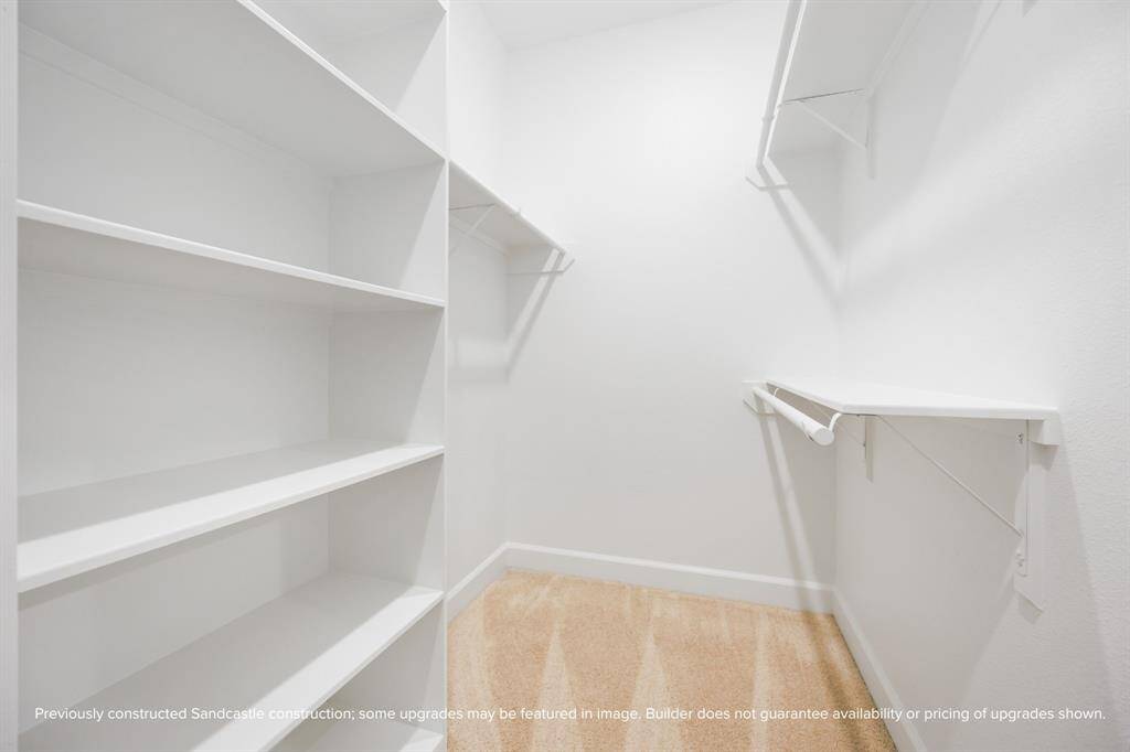 Morning routines are simplified with a walk-in closet just steps from the en suite bath—organized, efficient, and thoughtfully laid out.