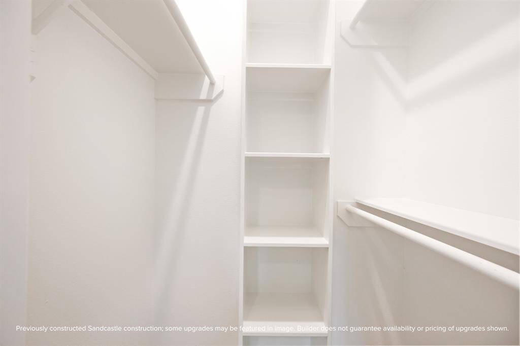 The walk-in guest closet includes built-in shelving to keep everything tidy.