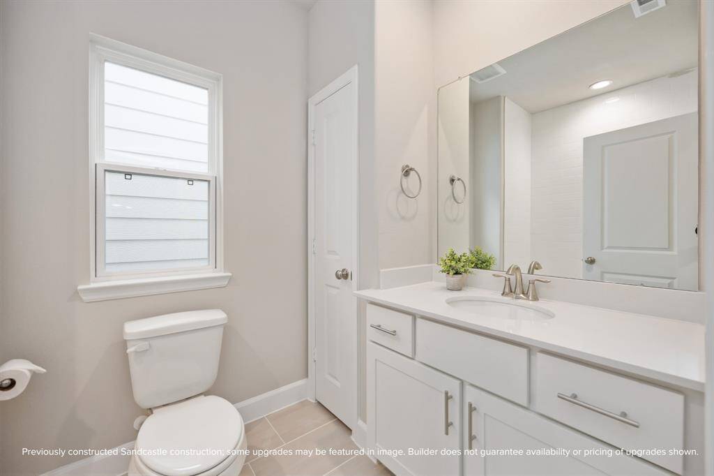 The upstairs hall bath features a classic tub/shower with tile surround, quartz vanity, and brushed nickel fixtures—clean, classic, and ready