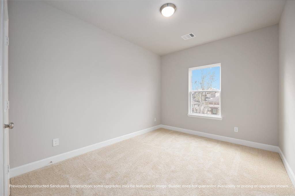 The third bedroom upstairs is bright and adaptable—perfect as a nursery, guest room, or creative workspace.