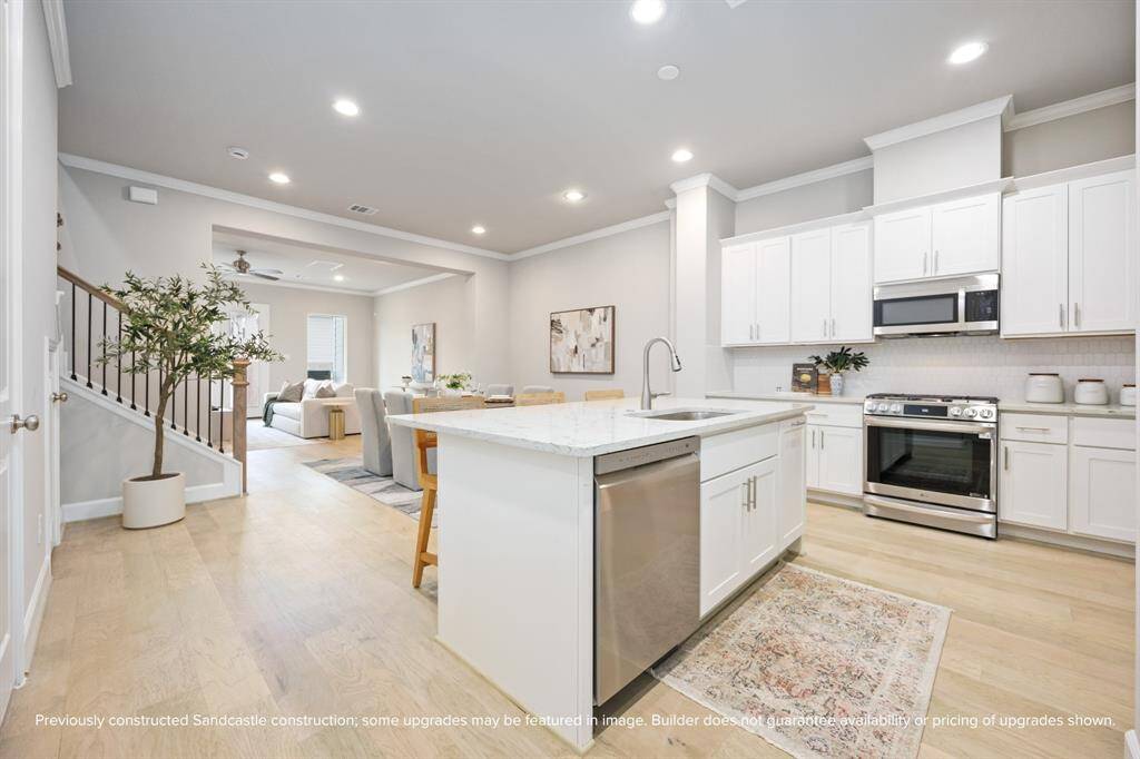 Wood floors with a 25-year manufacturer’s warranty set the tone for a main floor that flows easily from prep time to play time—ready this July.