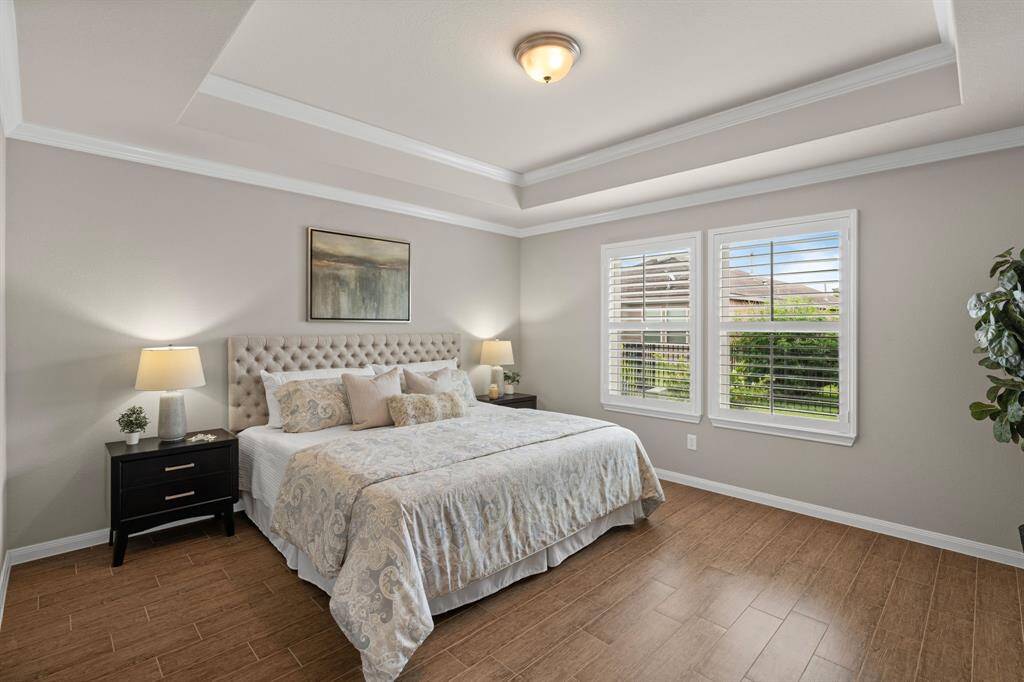 The owner’s suite features a tray ceiling with elegant double crown molding, adding a touch of sophistication and style.
