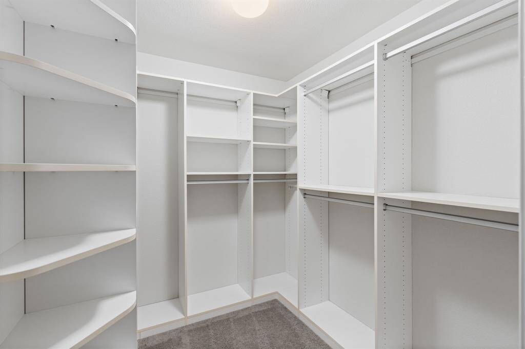 The closet features a professionally installed organization system, maximizing storage and functionality.