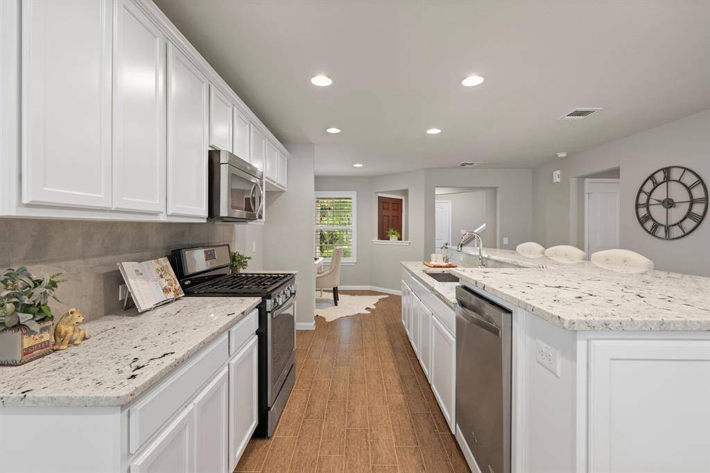 Dishwasher is elevated 6" to make loading and unloading easier.