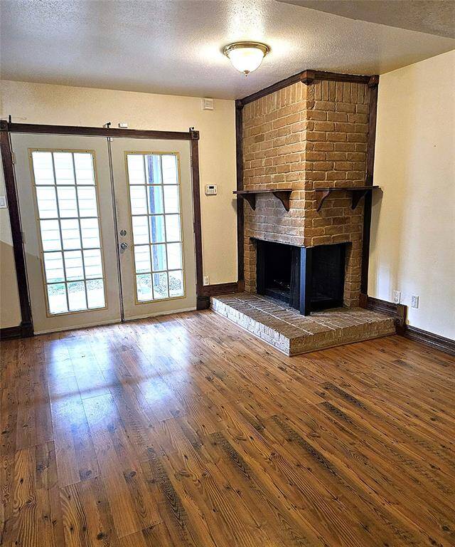 Brick fireplace across from kitchen and dinette area.