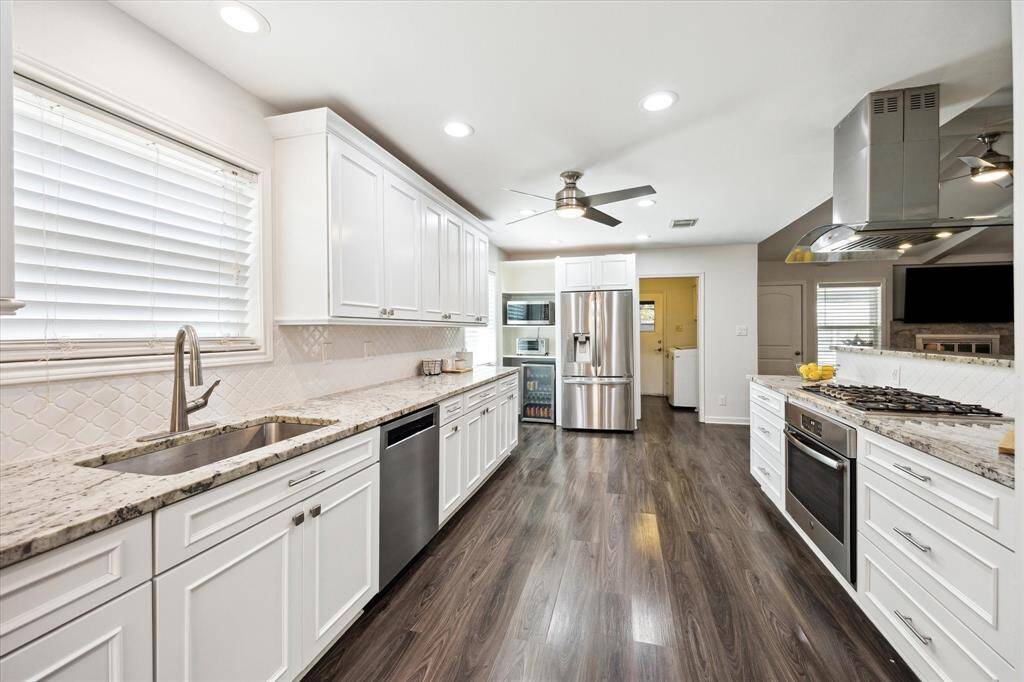 Granite counters, under-mount sink, and extended cabinetry create a polished, practical space - again with a lot of room for prep.