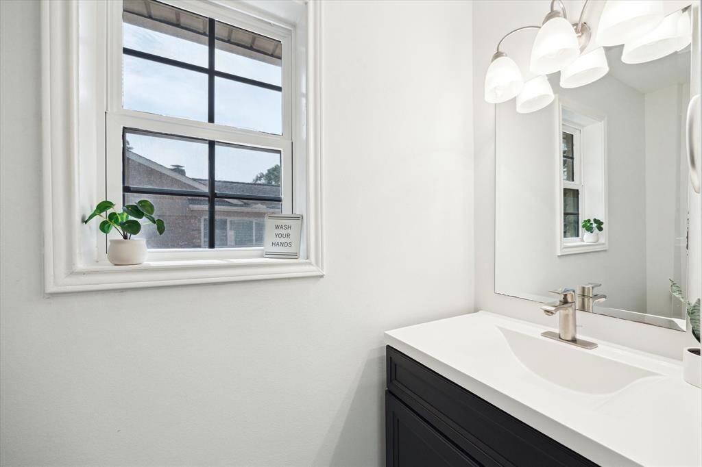 Powder room conveniently located off the utility room.