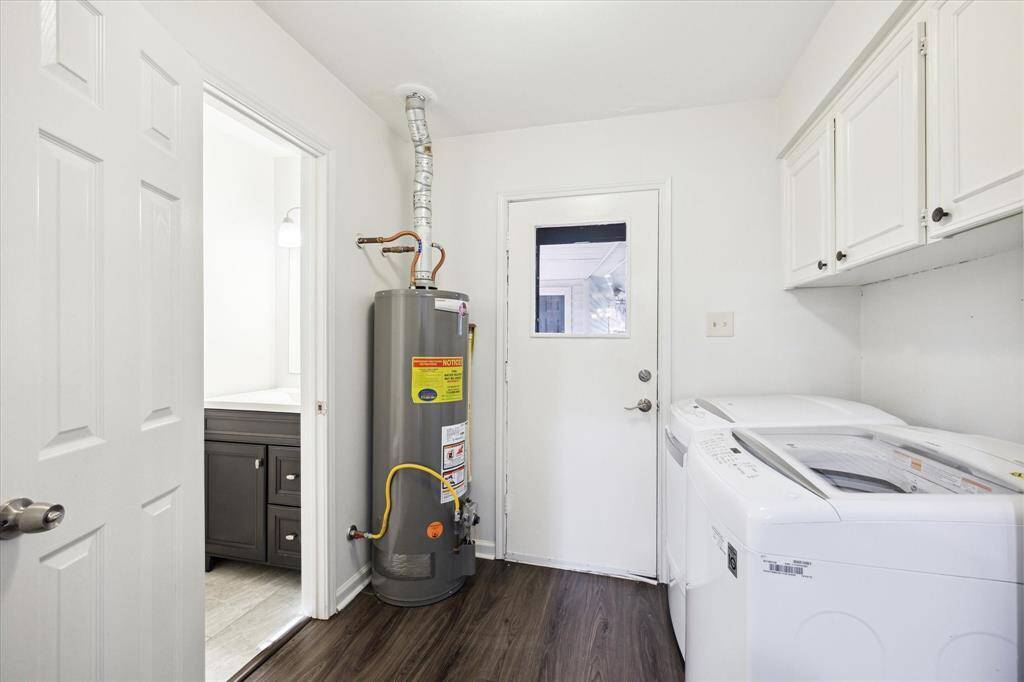 Utility room with attached powder room, cabinets, and storage closet (out of view)