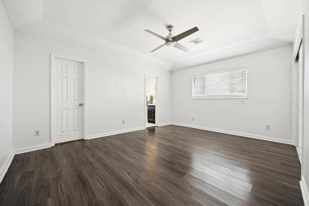Tucked at the back of the home, the spacious primary suite features recessed lighting, a walk-in closet + an additional closet, and a beautifully renovated en-suite bath.