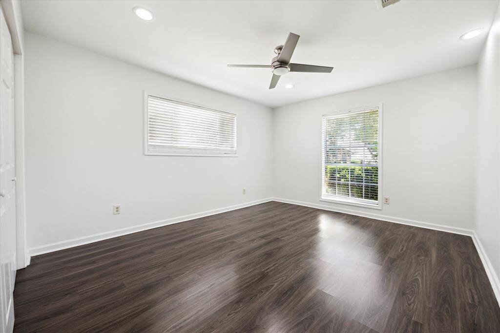 Another spacious bedroom located at the front corner of the home flooded with natural light, ample closet space, and recessed lighting.