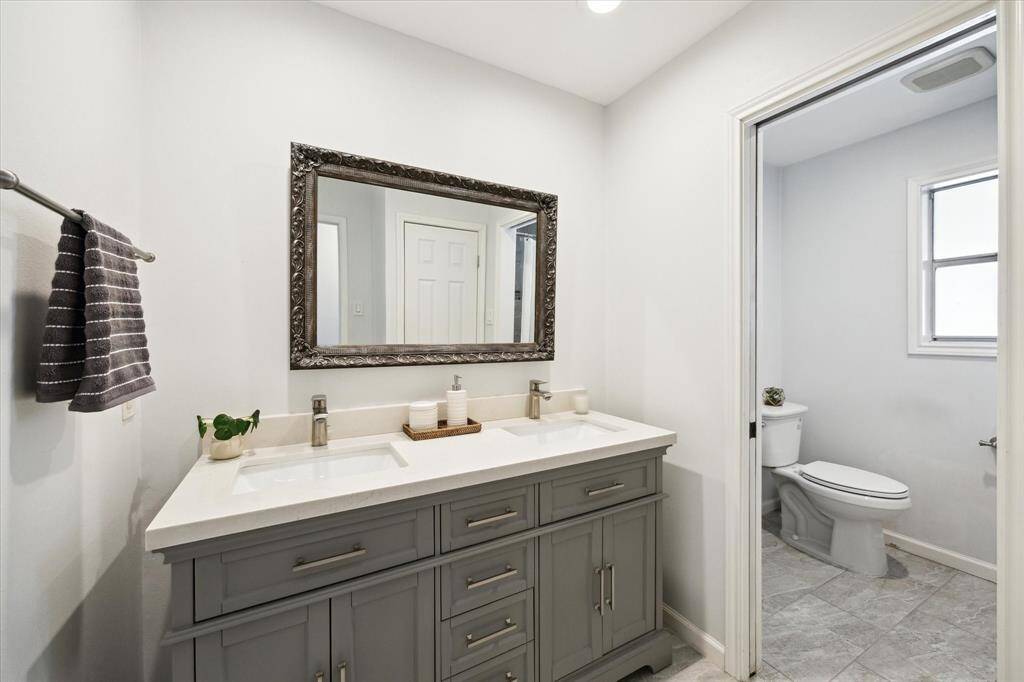 Renovated in 2019, this roomy secondary bath features double sinks, linen closet, and tub/shower combo.