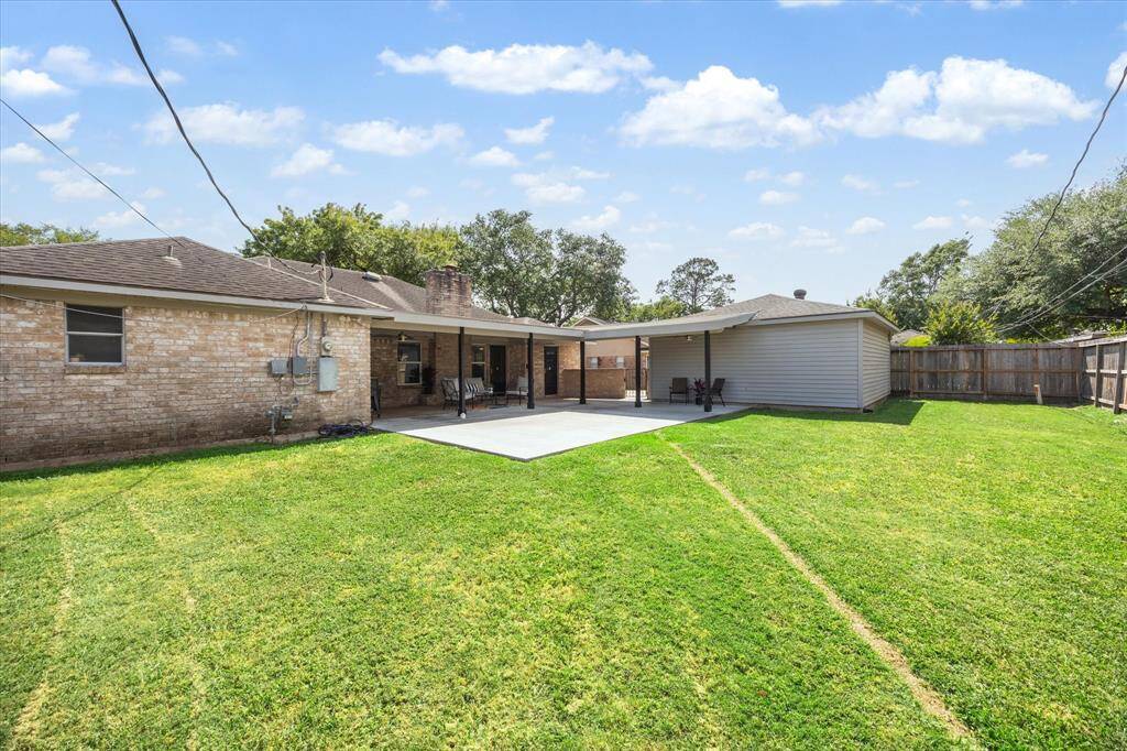 This sprawling backyard  provides room to roam, play, or garden and can easily accommodate a pool.