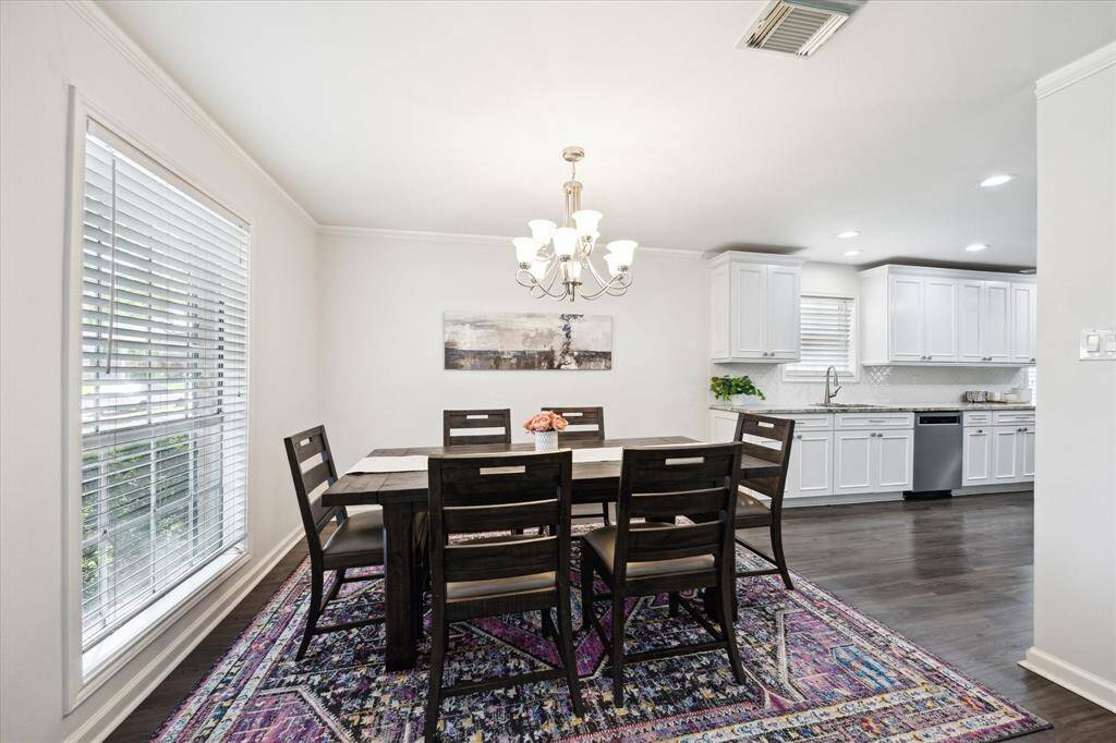 Located at the front of the home, the dining area features a generous window that fills the space with warm natural light. It seats six comfortably, with room to expand for larger gatherings.