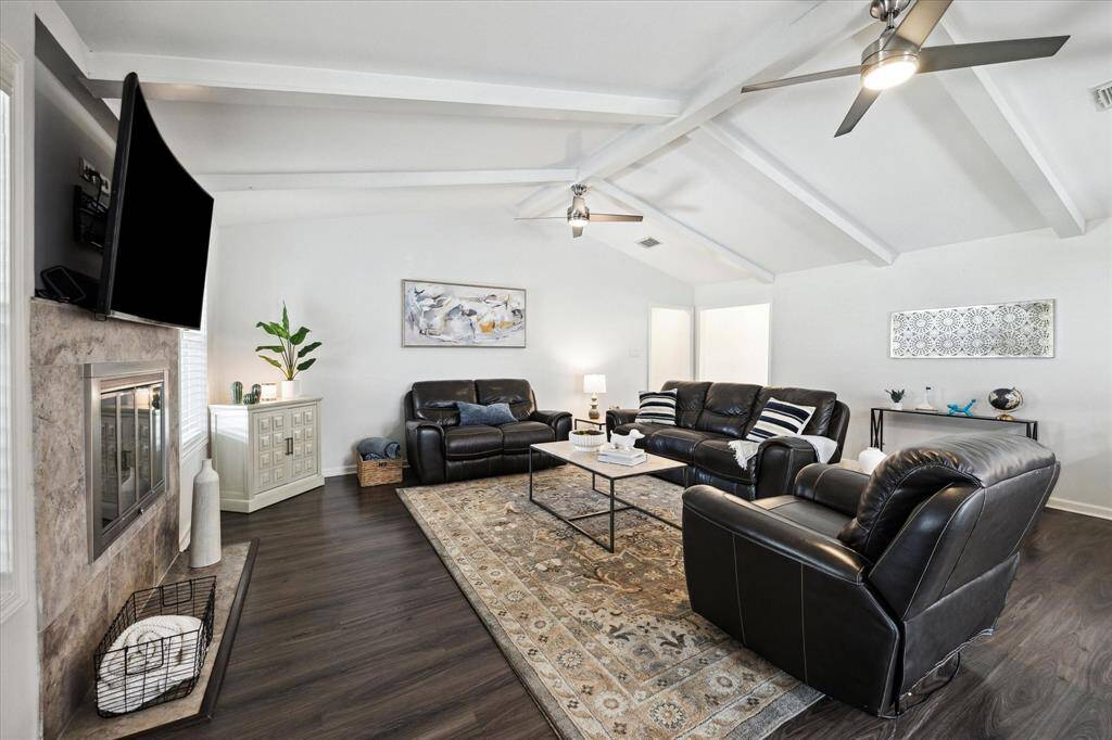 Located at the rear of the home, this spacious family room features vaulted ceilings with wood beams and a gas-long fireplace for those cozy winter nights.