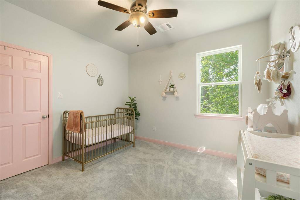 This light-filled room features a soft color palette, ceiling fan, and a large window that brings in plenty of natural light. Whether used as an every day bedroom, guest room, or home office, this flexible space is ready to fit your lifestyle.