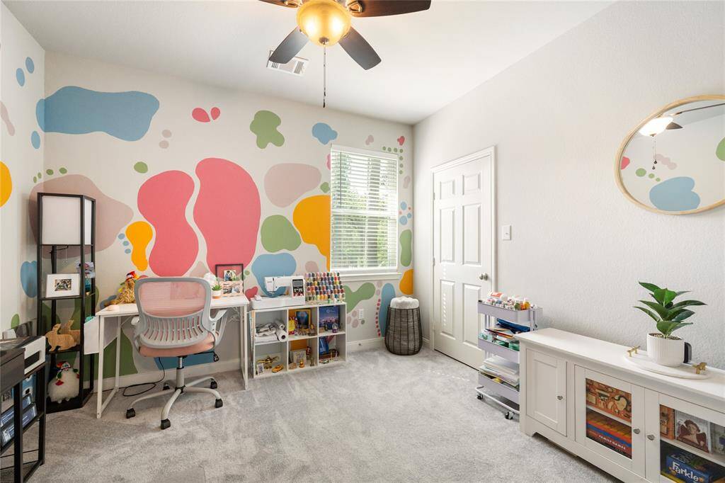 Filled with natural light, this vibrant and flexible room features an cozy carpeting, and a ceiling fan for added comfort. Whether you envision it as a home office, creative studio, or a bright bedroom, this space offers endless possibilities to make it your own.