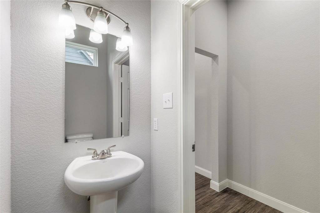 The half bath downstairs is ideal for quick access and perfectly located for ease of use, it adds a practical yet polished touch to the home.