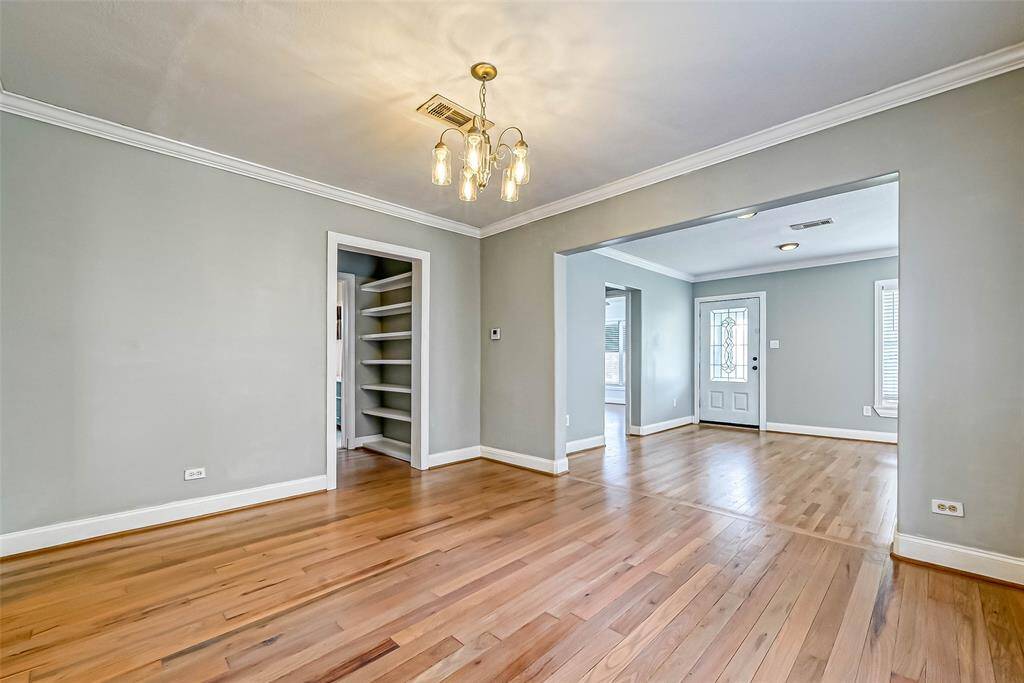 Looking from the kitchen toward the front of the home, to the left you can see the built in shelves allowing for plenty of storage or a decor display area.