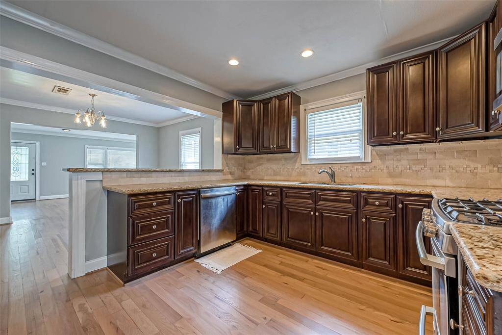 Remodeled kitchen with granite countertops and a gas range