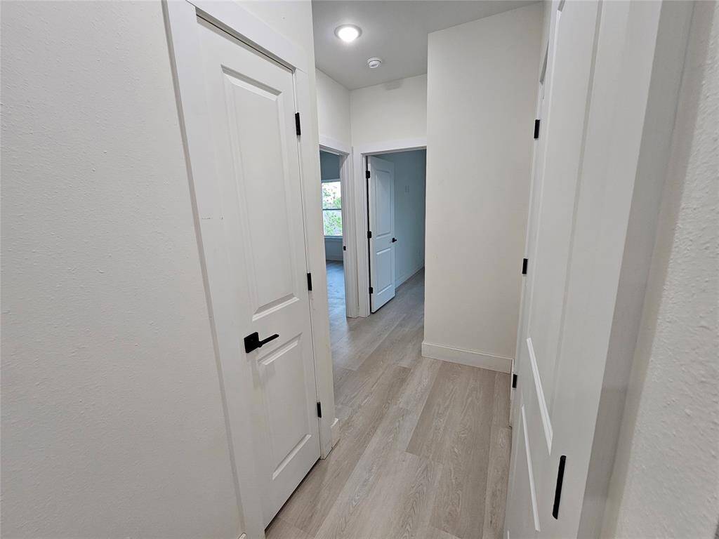 Hallway to 2nd and 3rd bedrooms, and laundry room.