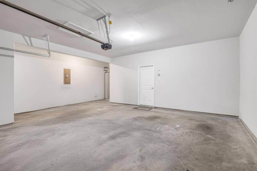 Spacious 2 car garage, with additional work space on the left.