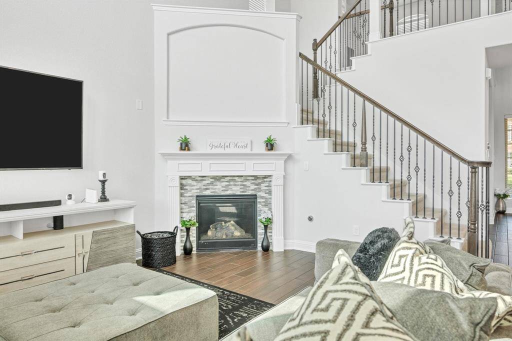 Den with soaring ceilings and fire place.