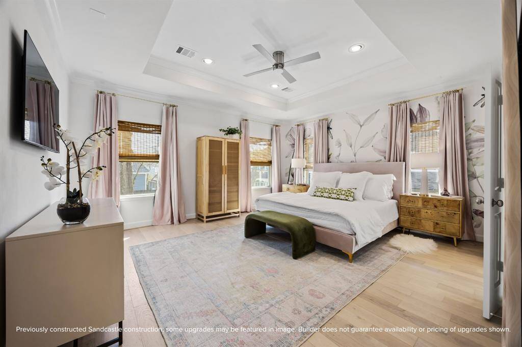 Peaceful and perfectly proportioned, the primary suite features a tray ceiling, beautiful natural light, and space to make it your own.