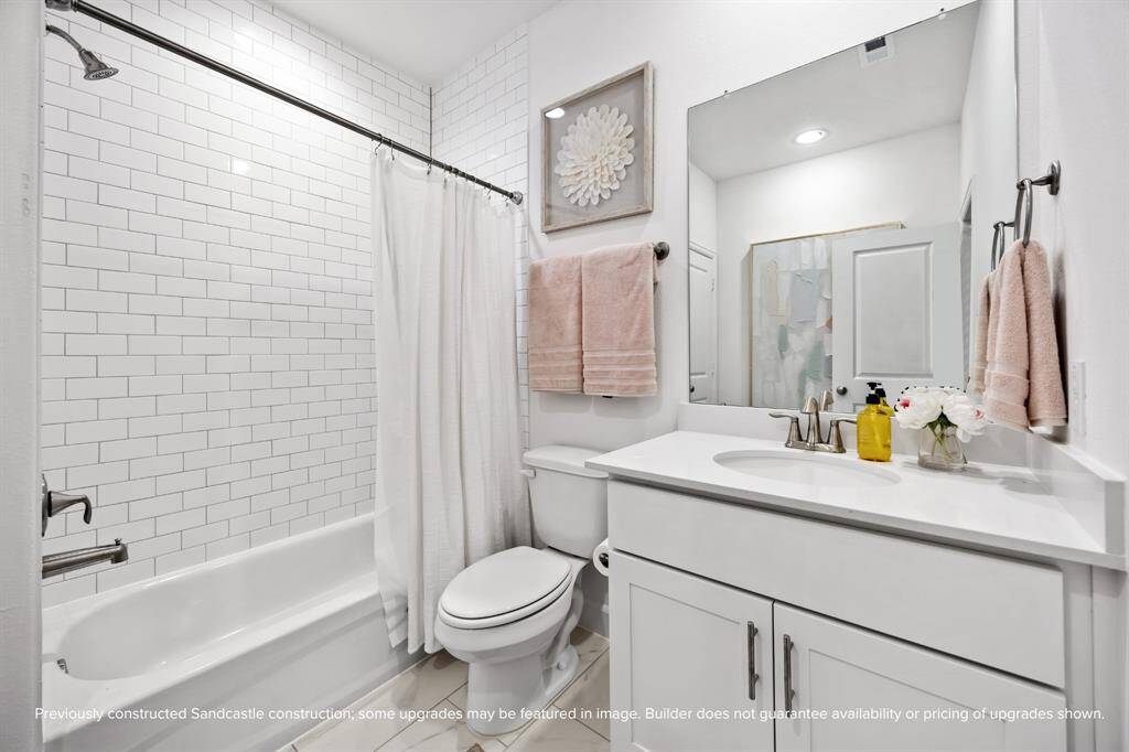 Classic and clean, this hall bath brings timeless design and everyday ease. Finishes like brushed nickel and subway tile never go out of style. (Finishes may vary.)