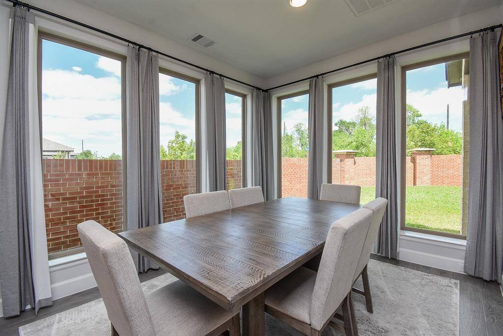 Enjoy the view or your outdoor gardens. The Dining area is bathing in natural light from the wall of windows on all sides.
