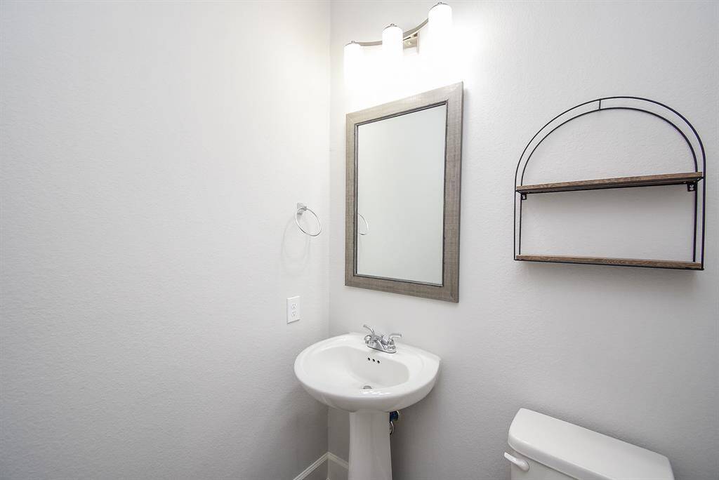 Downstairs half bathe with romantic pedestal sink.