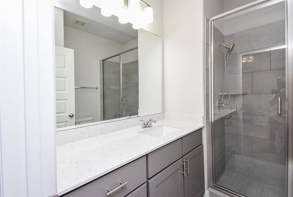 Guest bath with white stone and modern chrome fixtures