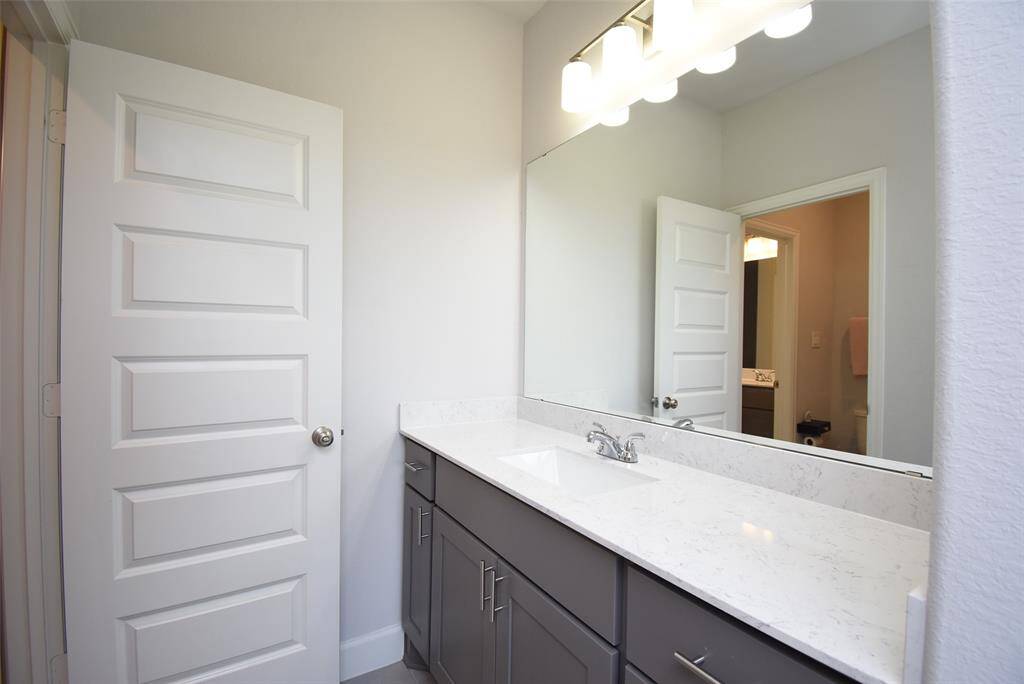 Upstairs Jack and Jill Bathroom with modern lighting fixtures
