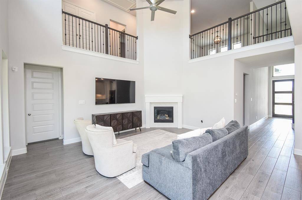 Living Room has, a cozy gas fireplace, tiled wood flooring, neutral palate to decorate as you please.