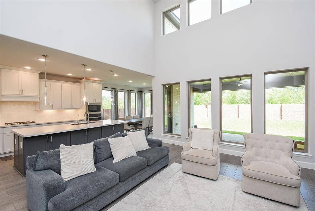 The open style living space room keeps the family together with an adjoining kitchen and breakfast area.