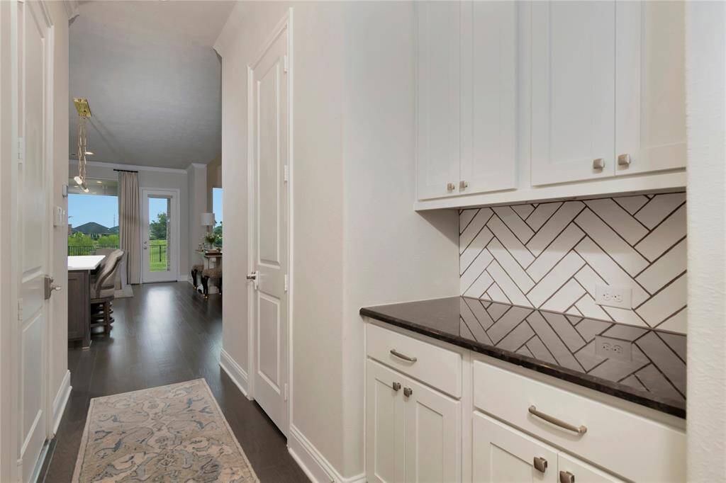 Butlers pantry with a large walk in pantry.